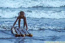 boy surfing on raft